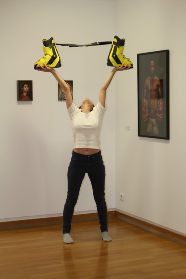 Vernissage de l'exposition Dialogues au musée Géo Charles. Une danseuse danse avec des chaussures de ski dans les mains. Elle se tient bien droite, les bras levés, une chaussure de ski dans chaque main. 