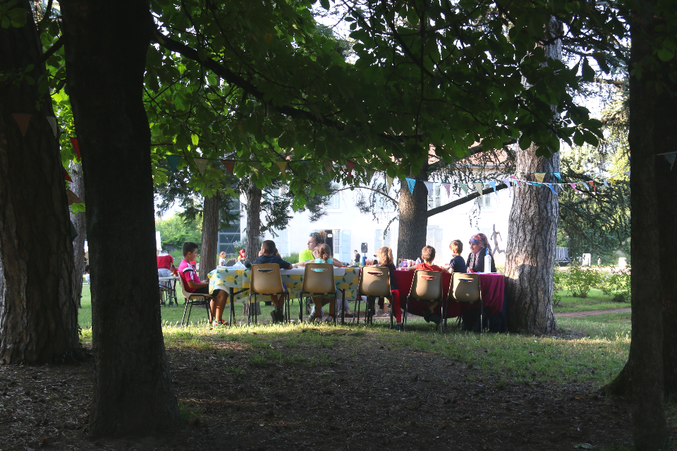 Cap sur les parcs à Géo-Charles Photo d'un atelier artistiques. Une animatrice accompagne une dizaine d'enfants assis autour d'une table.