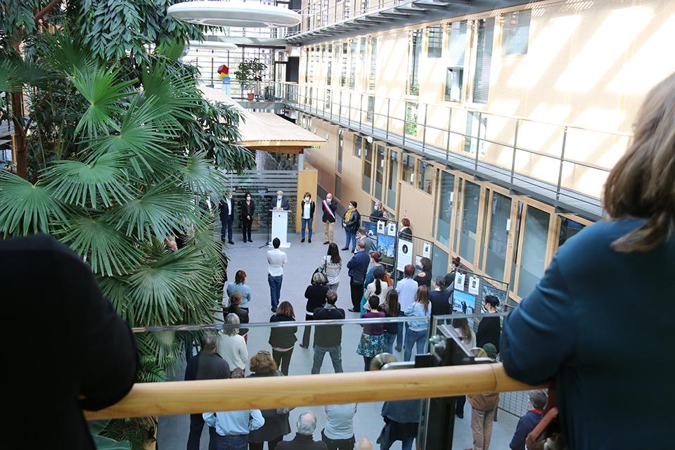 Vue depuis une passerelle surplombant l'atrium de l'Hôtel de Ville. Les élu-es et les agents sont regroupés pour 1 minute de silence afin de rendre hommage à Samuel Paty